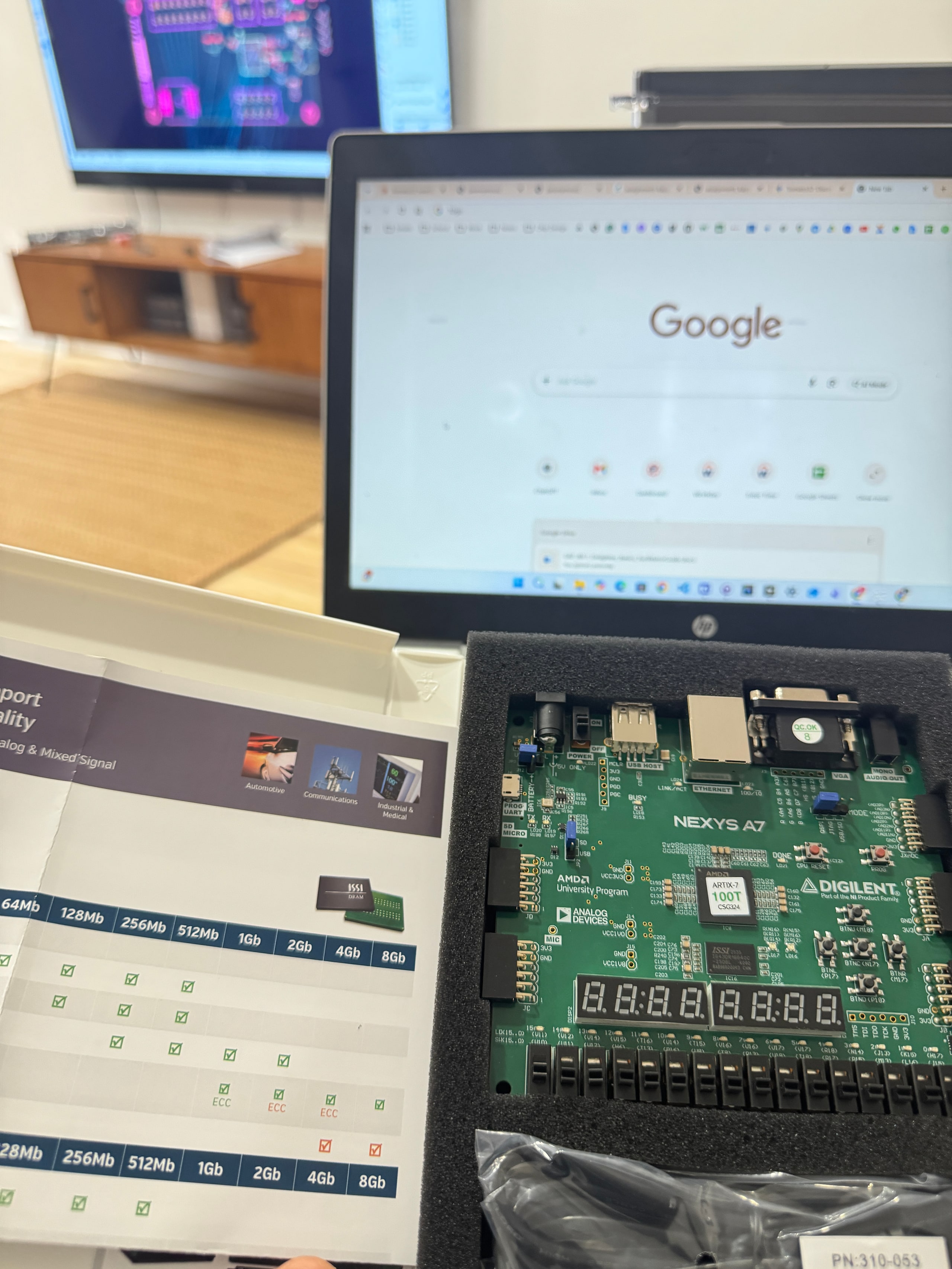 Nexys A7 Artix-7 FPGA board with the lid off on the desk.
